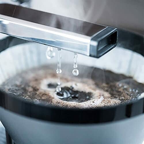 Close-up of coffee brewing with water dripping.