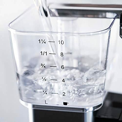 Water pouring into a clear measuring cup with measurement markings.